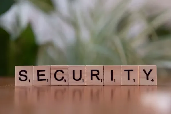 Wooden tiles spelling SECURITY, representing AI security audit fundamentals